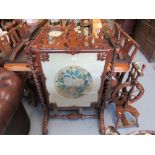 Victorian rosewood firescreen of Gothic design with barley twist uprights and scroll shaped feet