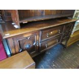 1930's / 40's Oak sideboard having panelled, carved and mirrored canopy back with two central