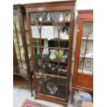 Narrow mahogany display cabinet with a moulded cornice above a single arched glazed door,