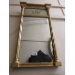 Small Regency gilt wall mirror with a gilt decorated panel above rectangular mirror plate