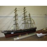 Wooden scale model of the Cutty Sark together with a scale model of an America's Cup yacht and an