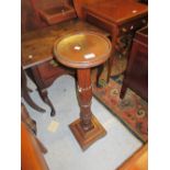 Mahogany carved and turned column torchere together with a reproduction gilt composition wall mirror