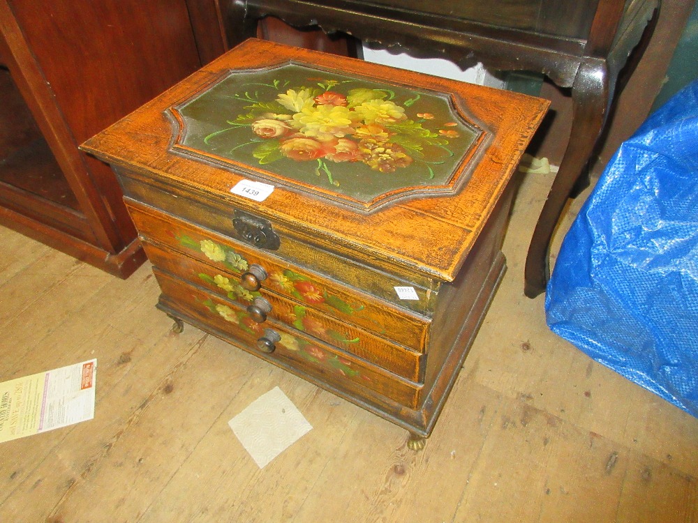 Small reproduction painted table cabinet with a hinged lid above three drawers