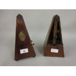 Two 19th Century walnut cased metronomes (one lacking door)