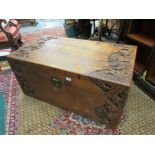 Oriental carved camphor wood trunk decorated in deep relief with stylised flowers, the hinged lid