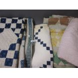 Three various patchwork quilts, an embroidered quilt and a Japanese jacket