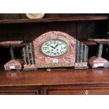 Large Art Deco red flecked marble and black and green onyx mounted three piece clock garniture,