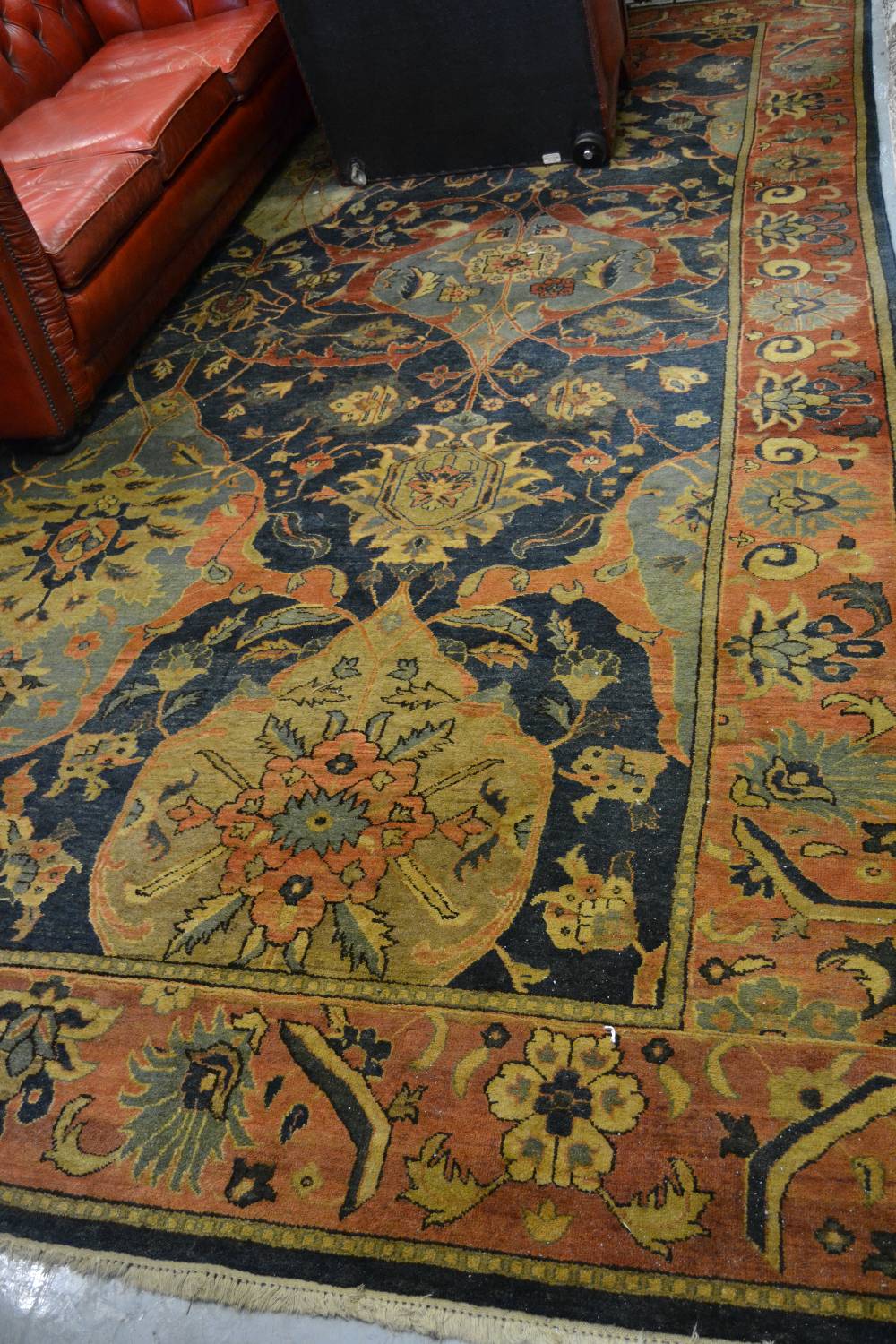 Agra carpet of all-over floral design on burgundy ground with multiple borders, 119ins x 167ins