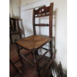 Pair of Regency elm country chairs with rush seats on turned front supports