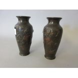 Pair of bronze Japanese baluster form vases decorated in high relief with flowers and birds, 6ins