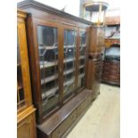 Mahogany bookcase, the moulded cornice above three satinwood crossbanded and astragal glazed