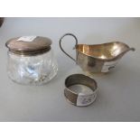 Birmingham silver cream jug, silver napkin ring and a silver topped dressing table jar