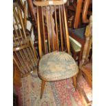 Set of six Ercol (four plus two) stick back dining chairs with a circular extending Ercol type