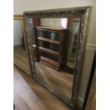 Large reproduction gilt framed bevelled edge wall mirror of water lily design, 55ins x 43ins