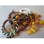 Quantity of native bead bangles, large amber bead, together with a quantity of other jewellery