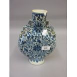 Chinese porcelain moon flask with blue and white floral decoration and dragon handles (at fault)