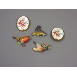 Group of three Royal Worcester porcelain brooches in the form of a mallard, a robin and a