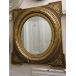 Pair of oval gilt moulded composition wall mirrors (one at fault)