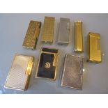 Four various gold plated Dunhill cigarette lighters together with three various Dupont cigarette