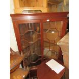 20th Century mahogany floor standing corner cabinet, having moulded cornice above two bar glazed