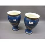 Pair of Wedgwood baluster form porcelain vases, gilt decorated with dragons on a blue ground, 9ins