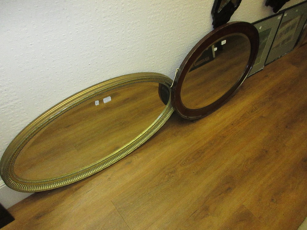 1920's Oval mahogany bevel edged wall mirror together with a reproduction oval gilt framed bevel