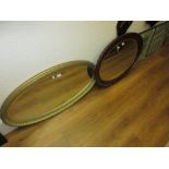 1920's Oval mahogany bevel edged wall mirror together with a reproduction oval gilt framed bevel