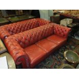 Pair of 20th Century red buttoned leather upholstered three seat chesterfield sofas raised on low