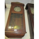 Early 20th Century Continental oak cased wall clock with a gilt metal torch and quiver surmount, the