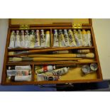 20th Century artist's colour box containing a quantity of various artists oil paints, brushes etc.