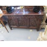 17th Century oak coffer, the hinged three panel lid above a carved frieze and three panel front on