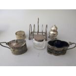 Silver toast rack, silver mounted glass inkwell, napkin ring and three various silver condiments