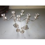 Pair of large plated three light candelabras and a pair of plate on copper candlesticks