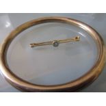 9ct Yellow gold bangle and a 9ct gold blue zircon set bar brooch 13g