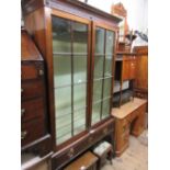 George III mahogany bookcase, the moulded dentil cornice above two astragal glazed doors, the base