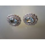 Pair of 9ct gold oval aquamarine and diamond cluster stud earrings