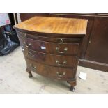 Small mid 20th Century mahogany bow fronted chest with a brushing slide above three drawers on