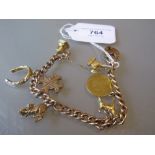 9ct Gold curb link charm bracelet with padlock clasp, the charms including a George III spade half