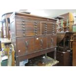 Mahogany two section Globe Wernicke type filing cabinet, the top section with twelve small drawers