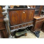 Reproduction mahogany cocktail cabinet with oval panelled doors above three drawers raised on carved