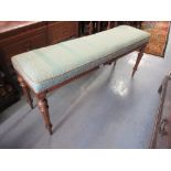 Reproduction French upholstered window seat on turned tapering fluted supports