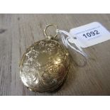 Victorian yellow double sided locket with engraved floral and chased decoration