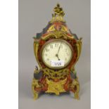 Late 19th or early 20th Century buhl mantel clock with a cut brass and red stained tortoiseshell
