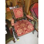 Victorian ebonised and gilded floral upholstered drawing room armchair on turned fluted tapering