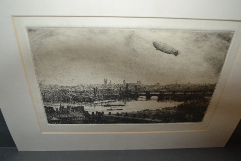Attributed to C.R.W. Nevinson, an unframed etching, study of the airship R101, above London (