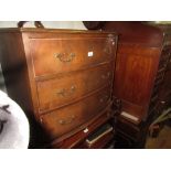 Reproduction mahogany three drawer bow front chest with brass handles and bracket feet