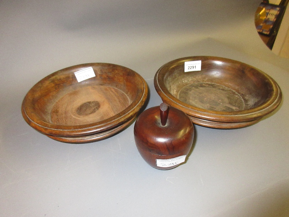 Two antique treenware coasters, one with a replacement base insert, together with a small