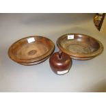 Two antique treenware coasters, one with a replacement base insert, together with a small