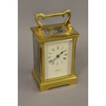 20th Century brass cased carriage clock with key, the dial inscribed ' Sladdens, Canterbury '