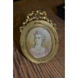 Oval portrait miniature of a lady housed in a good quality ormolu frame with bow surmount